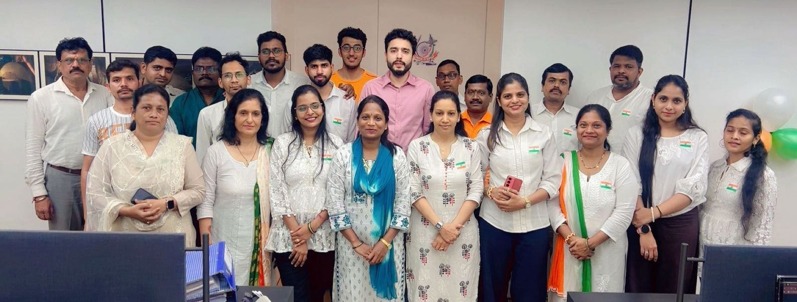 The Dmsons Metal office team standing together for a group photo, many wearing Indian flag badges