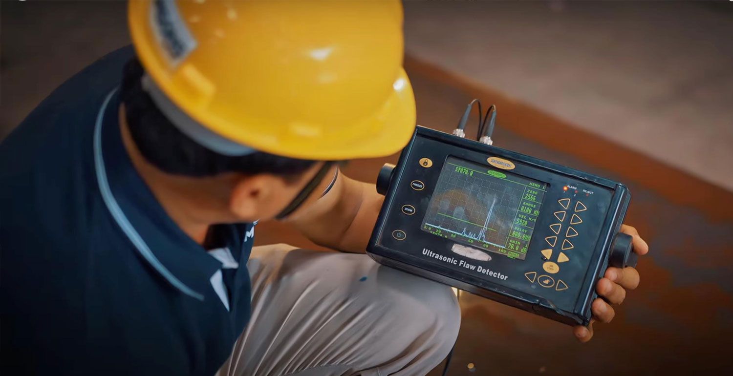 Technician holding an ultrasonic flaw detector